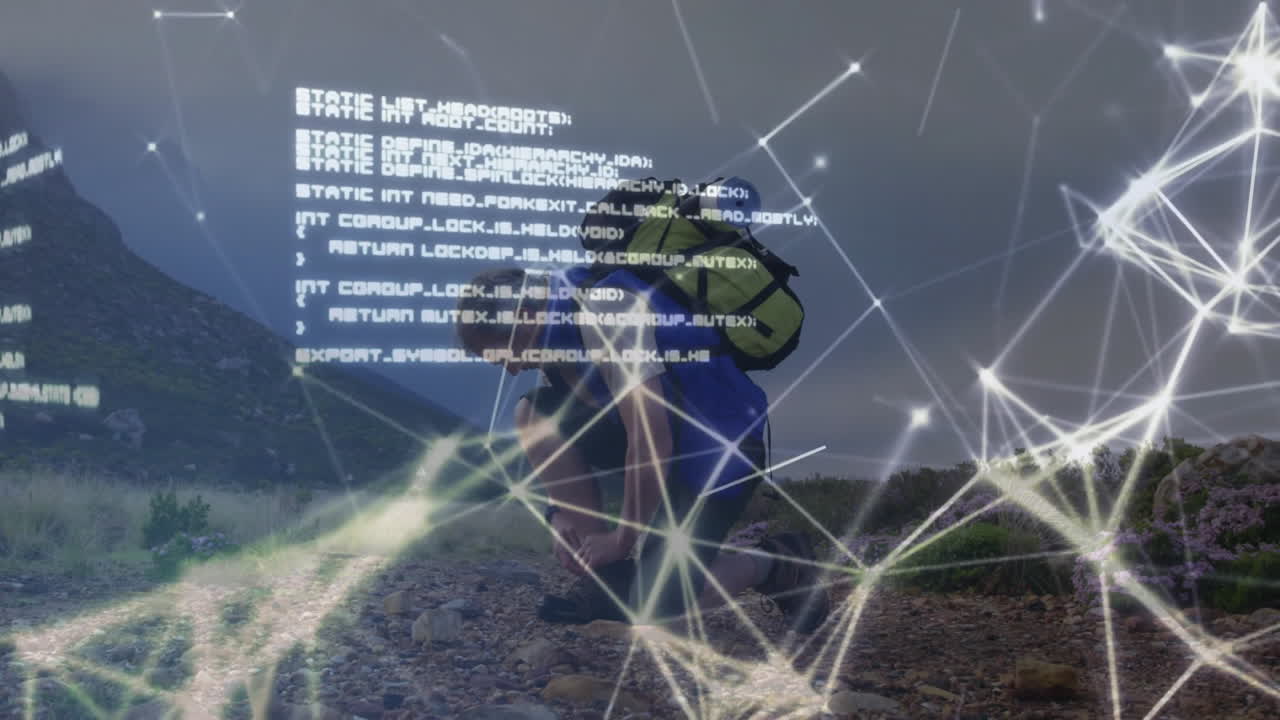 Male hiker kneeling tying boots beside yellow backpack on trail, featuring tech network code