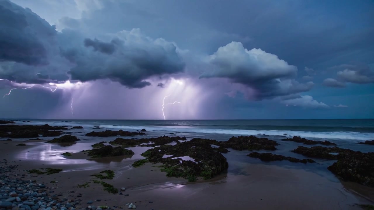 Advancing coastal thunderstorm intensifying over ocean, striking water and reflecting on tide pools