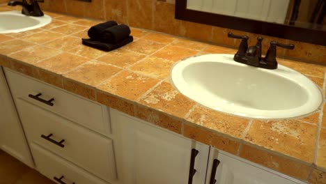 bathroom design with white cabinets and mosaic tile countertop and backsplash