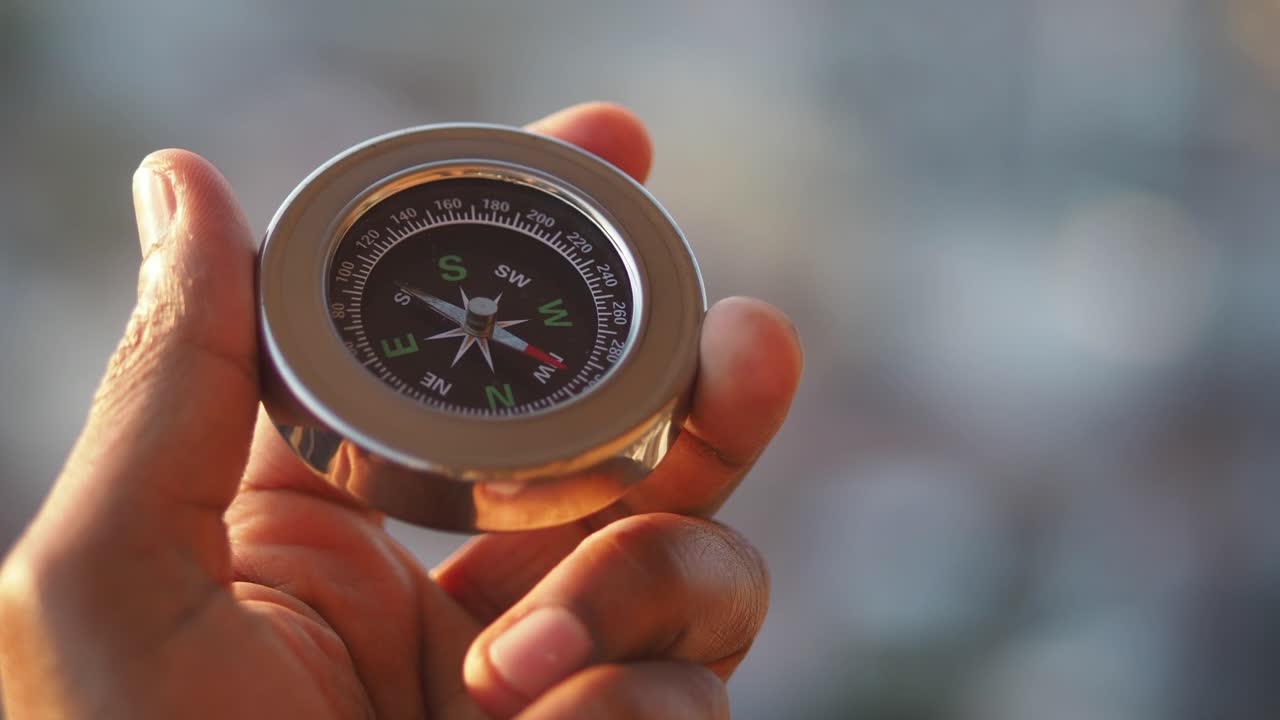 Close-up of a Compass Held in Hand