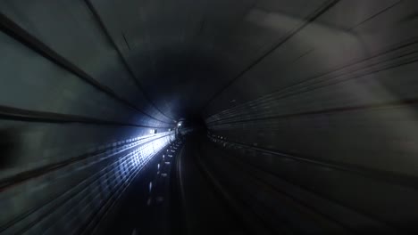 landscape view from the front of the subway train while moving in the underground tube in the big metropolis city center