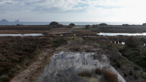 aerial view colourful sky reflections in costa brava grassland shoreline with medas islands on the skyline