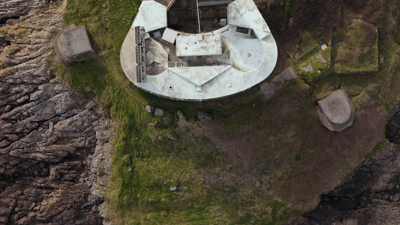 Motion video of Mumbles Lighthouse architecture on a rocky terrain near Swansea at United Kingdom. Aerial shot.