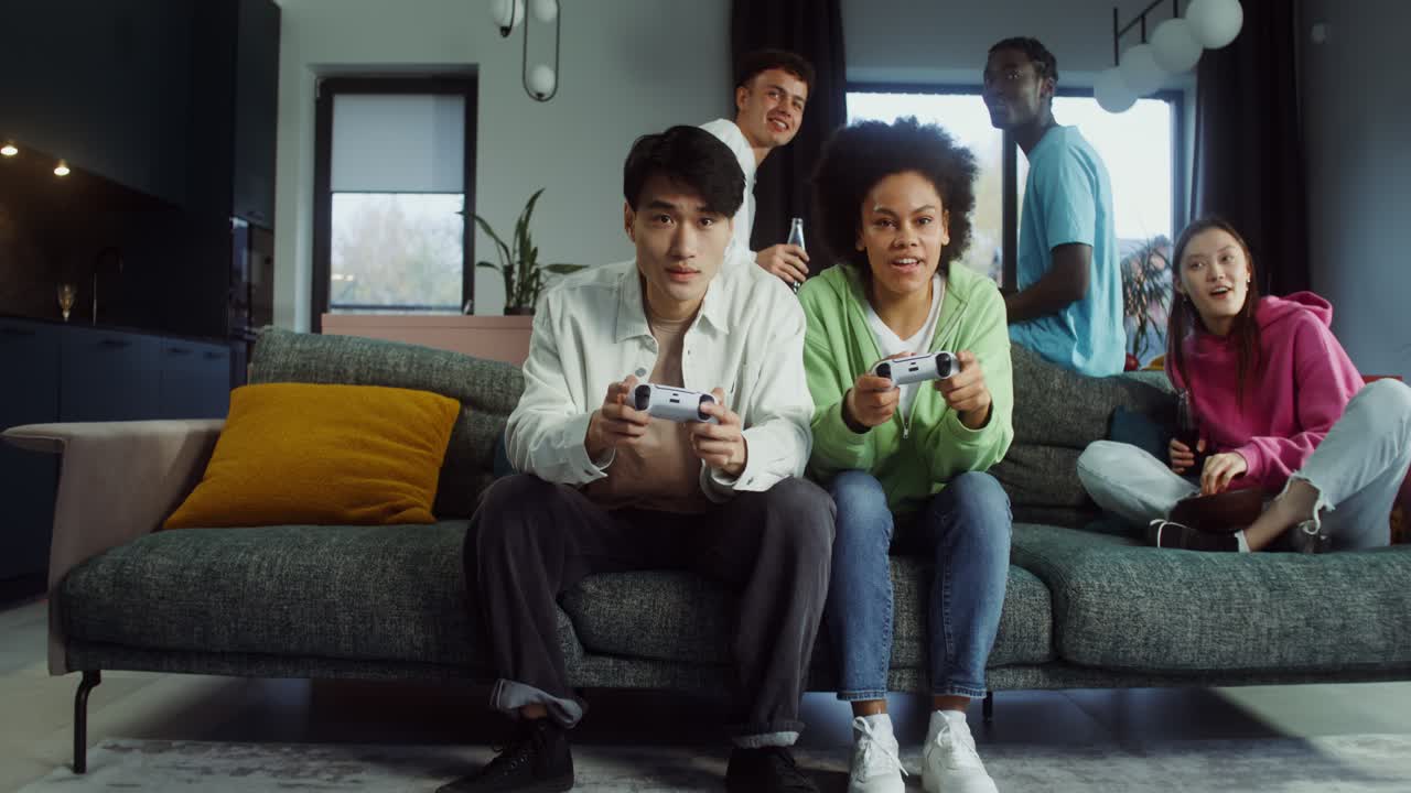 Friends having fun playing video games together