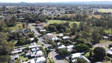 4k aerial view part of an australian regional town with streets and cars passing by
