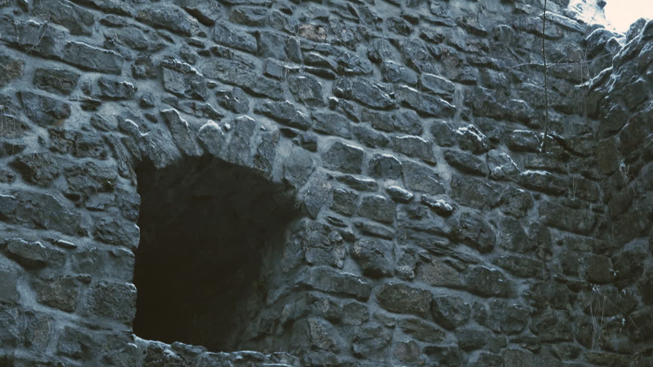 Window of an old ruined castle in winter