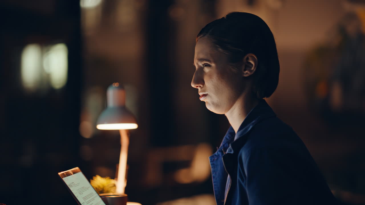 Overloaded teammates discussing deadline task in dark workspace office closeup