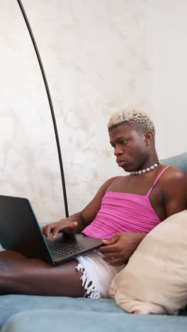 person using laptop on couch
