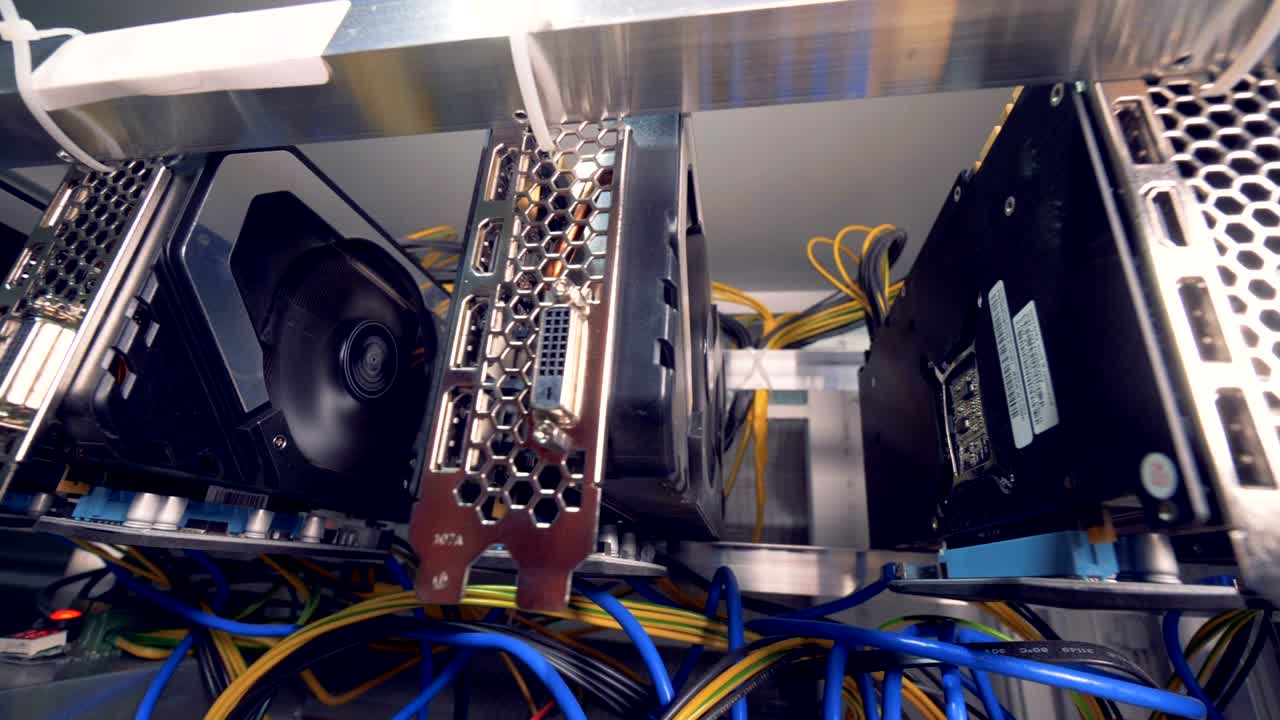 Graphic cards working connected into mining cryptocurrency farm. 4K.