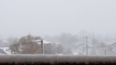 heavy snowfall on electric poles and wires in a town