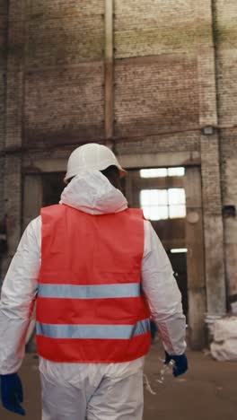 worker in protective gear in a recycling plant