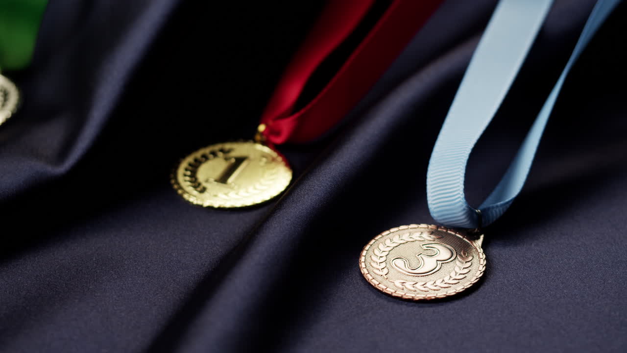 Close-up of Gold, Silver, and Bronze Medals on Dark Fabric