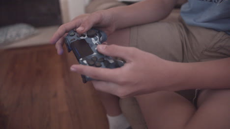 a young boy plays video games with a controller