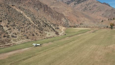 Drone-footage-following-a-backcountry-single-engine-plane-taking-off-from-a-remote-airstrip-over-a-river-in-the-Frank-Church-River-of-No-Return-Wilderness