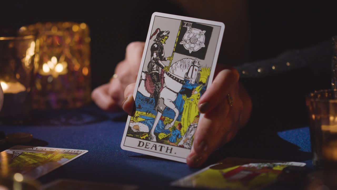 Close Up Of Woman Giving Tarot Card Reading On Candlelit Table Holding Death Card 5