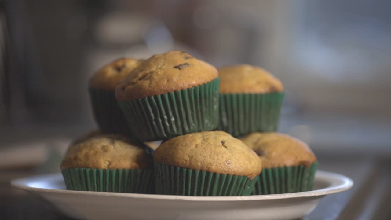 A Pile Of Delicious Muffin On White Plate With Blurry Background. - close up shot
