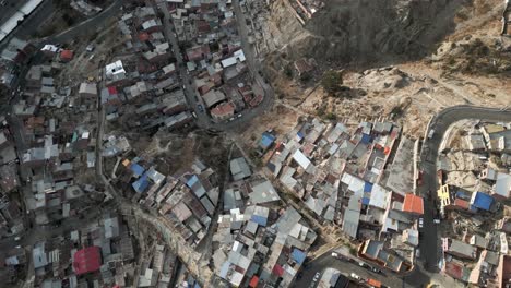 aerial top view of a large slum on the mountainside of la paz, bolivia streets, houses, cars traffic, latin america capital city