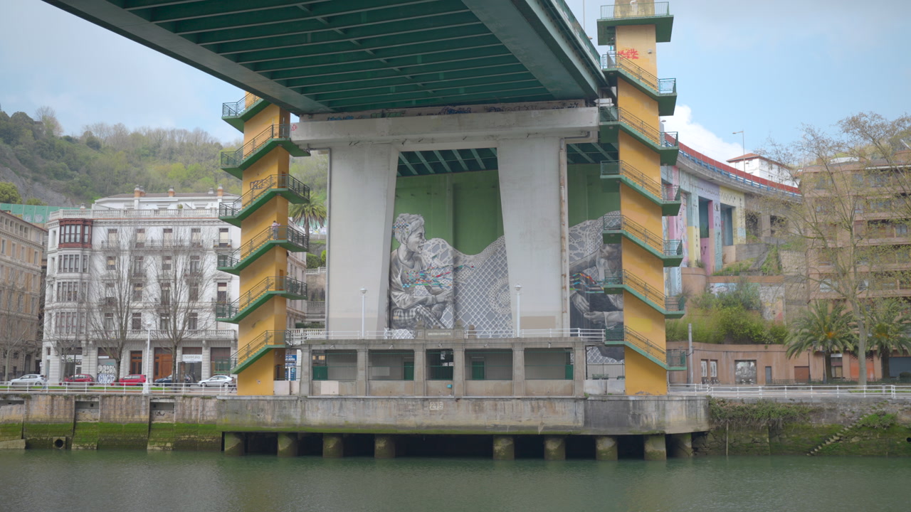 Under Bridge Mural River Pillar With Yellow Stair Towers, Concrete Column Painted With Giant Grayscale