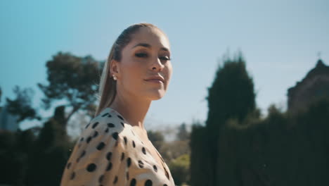 stylish young woman walking through the park.