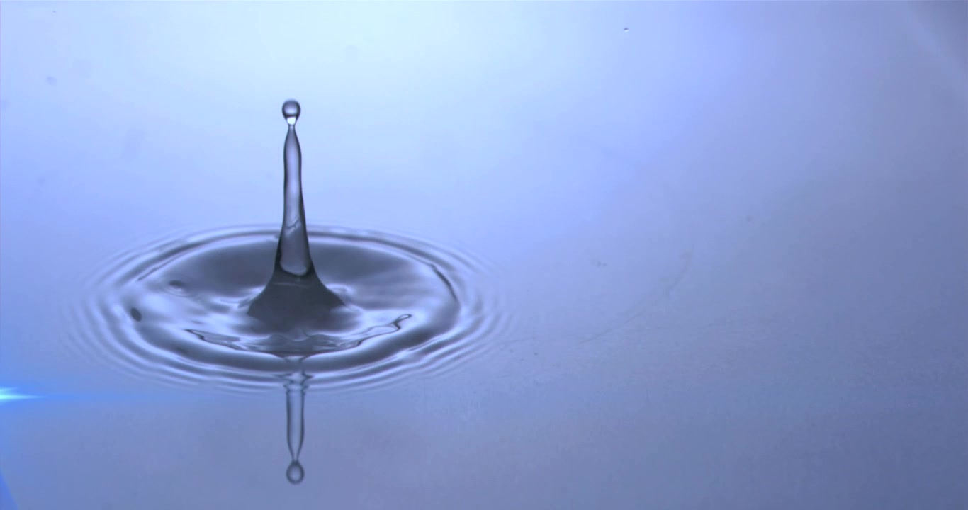 Animation of water drops dropping into blue water with glowing light