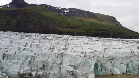 Glacier-in-Iceland-with-mountains-with-drone-video-moving-close-up