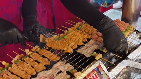 grilled skewers being prepared at a street food stall