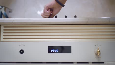 female hand including gas hob on kitchen stove. woman hand using gas stove