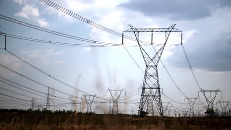 a large group of tension towers producing energy and electricity outdoors in daylight.