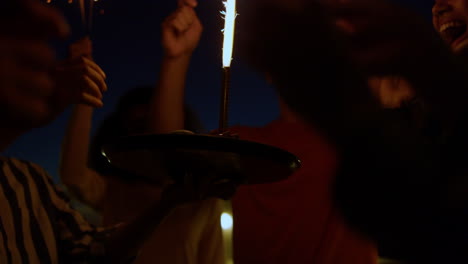 People-celebrating-birthday-with-cake.-Friends-having-fun-with-sparklers.