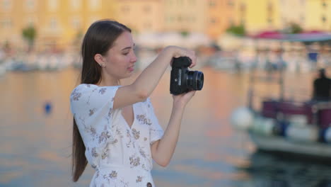 mujer tomando una foto en un puerto marítimo