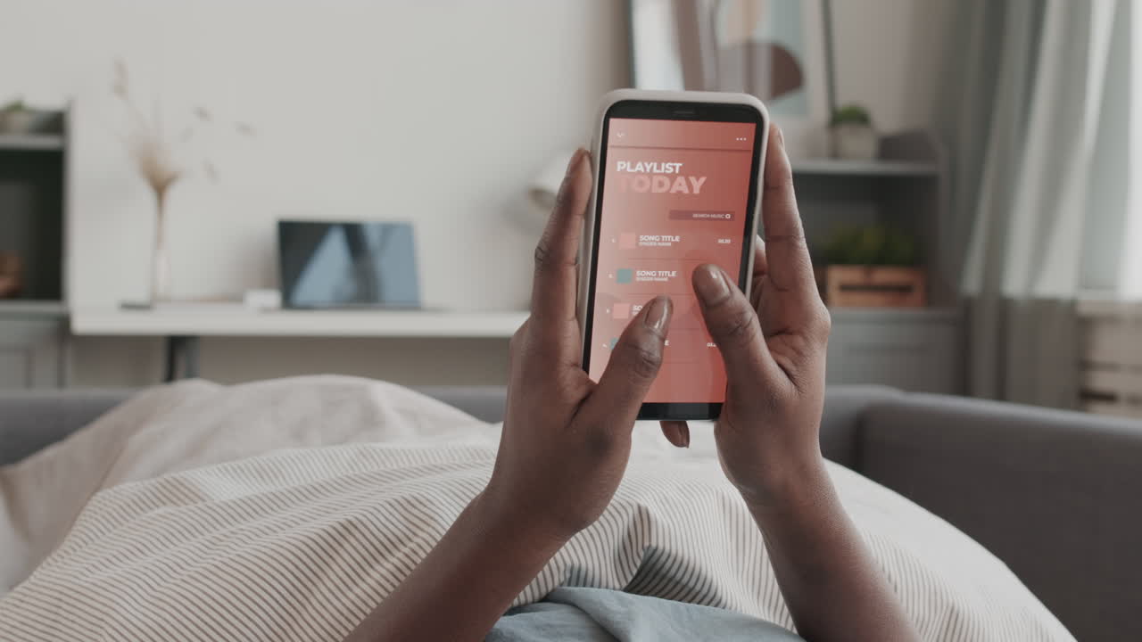 Unrecognizable African-American Woman Using Phone in Bed