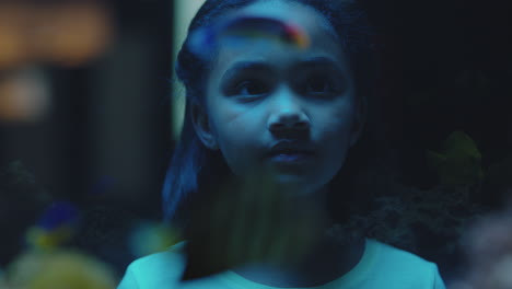 curious-girl-looking-at-fish-in-aquarium-child-watching-colorful-sea-life-swimming-in-tank-learning-about-marine-animals-in-underwater-ecosystem-inquisitive-kid-at-oceanarium