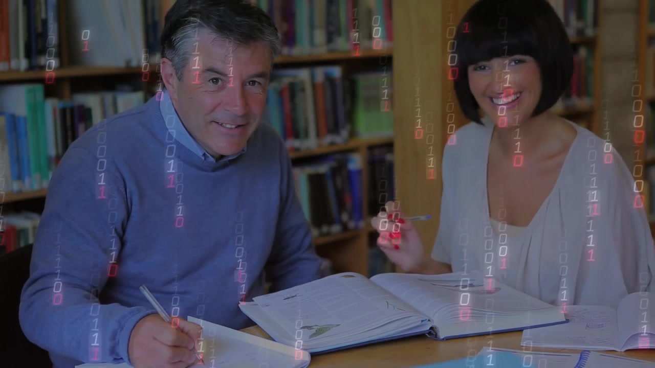 Study partners pointing at plant diagram with red pen, activating binary overlay and sharing notes