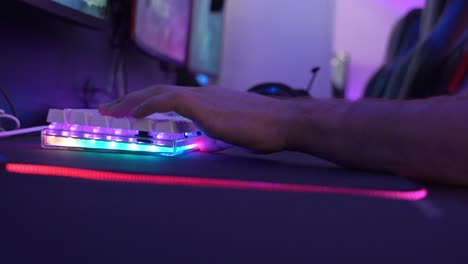 man typing on a white keyboard while playing an online game