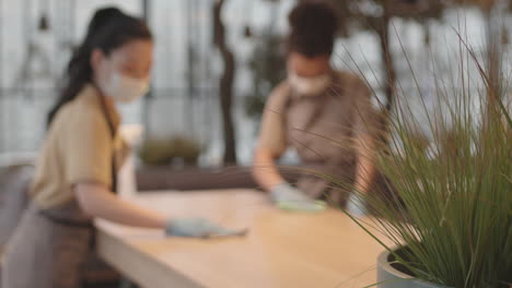 blurred people cleaning table indoors