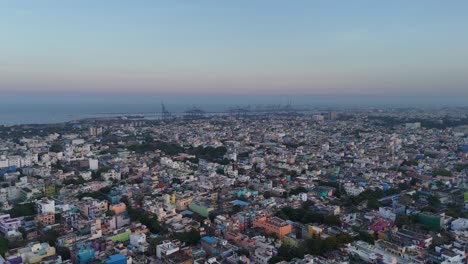 drone footage capturing dense housing clusters near a sprawling railway yard