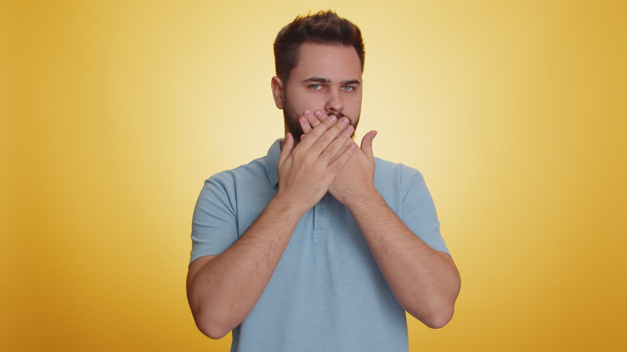 Frightened scared man closing his mouth with hand gestures no refusing to tell terrible secret