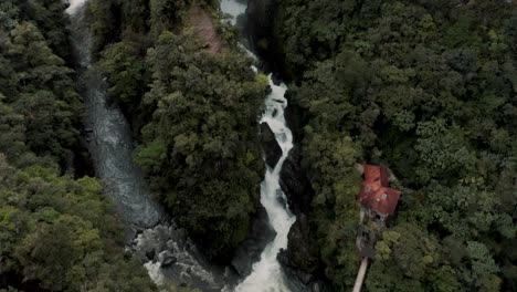 Overhead-View-Of-Rocky-River-And-Pailon-del-Diablo-Waterfall-In-Baños-de-Agua-Santa,-Ecuador