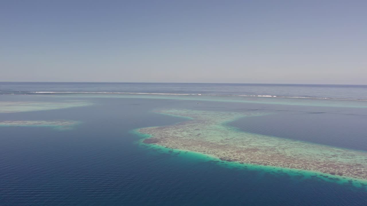Slow Left Pan Aerial Drone Footage of the Coral Reef and Lagoon in Tahiti