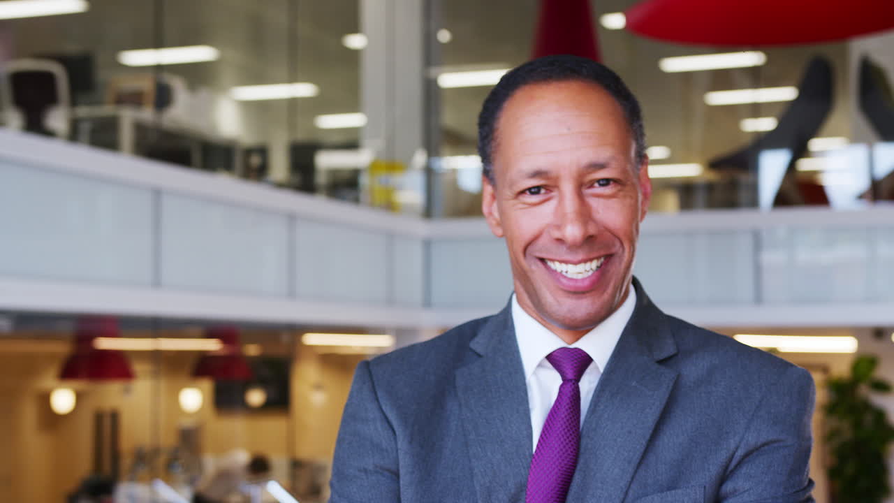 Middle aged businessman walking into focus in an office