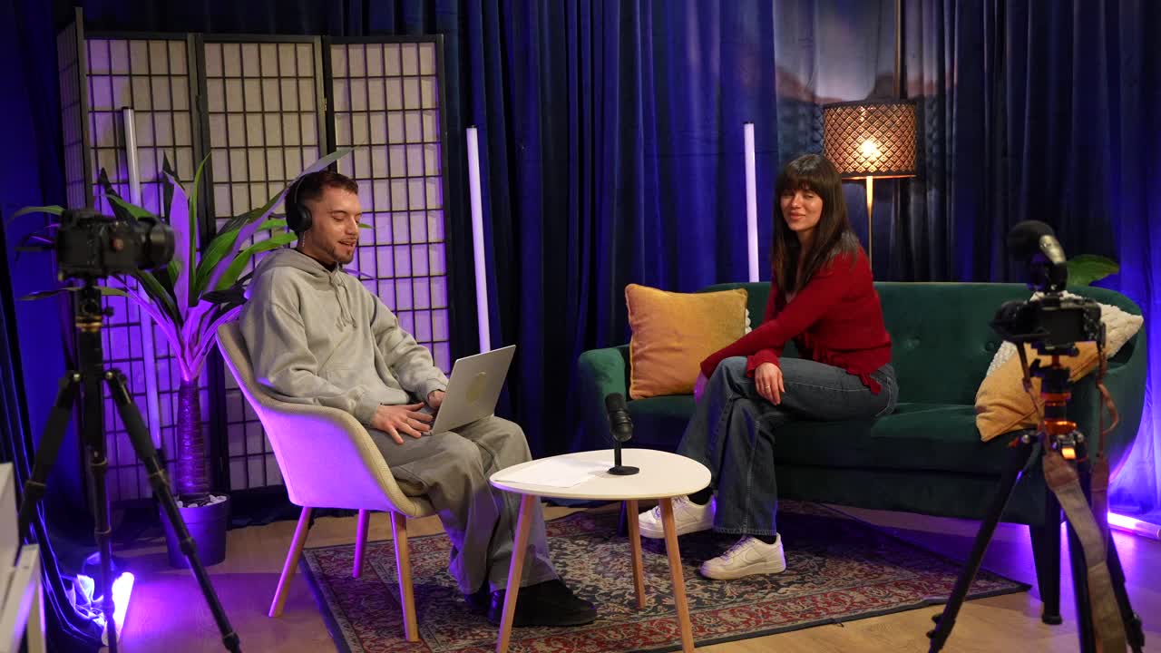 Man and Woman Recording a Podcast Interview in a Modern Studio
