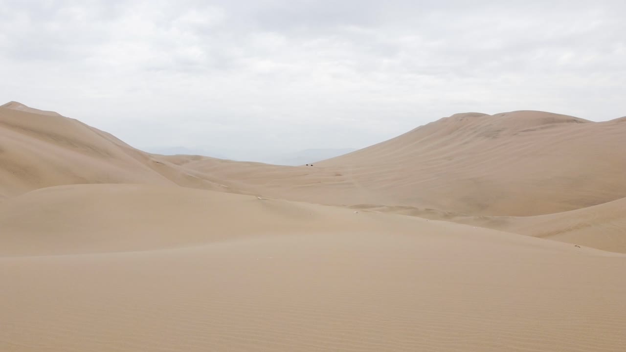 Veduta aerea di vaste dune di sabbia sotto un cielo nuvoloso