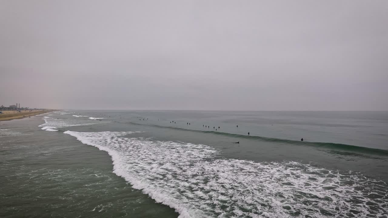 Surfers sitting on their boards in the ocean waiting for waves