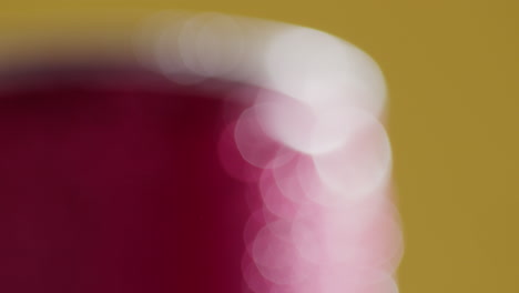 defocused close up of condensation droplets on takeaway can of cold beer or soft drink against yellow background