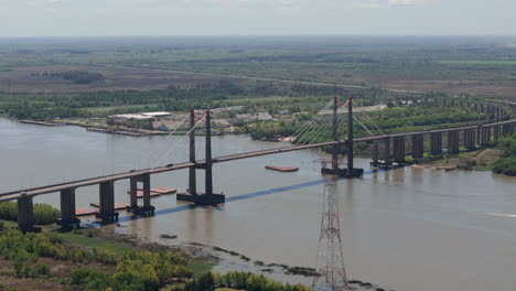 aerial view of a long cable-stayed bridge over a wide river
