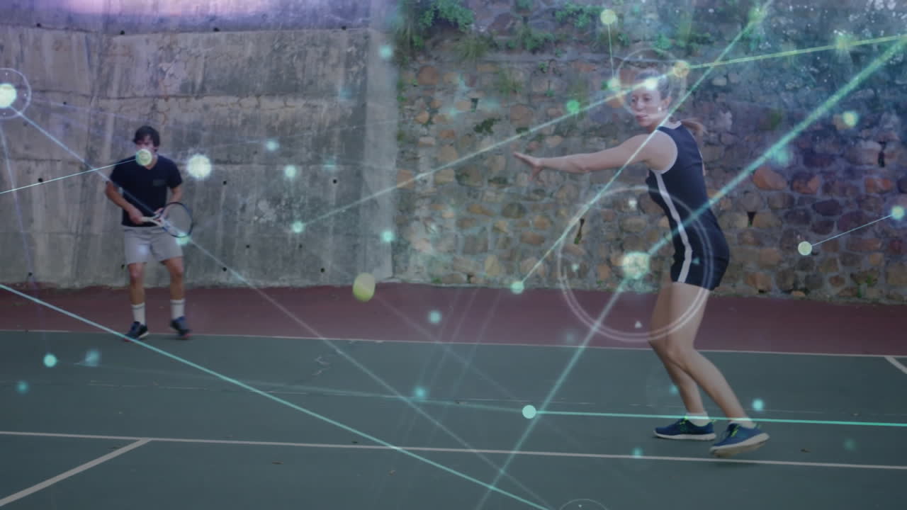 Tennis partners practicing on court, displaying glowing network graphics for sports technology