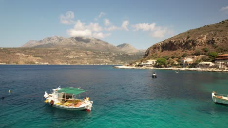 A-drone-moves-slowly-sideways-revealing-two-beautiful-fishing-boats-on-a-calm-summer-day