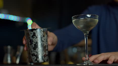 bartender pouring a cocktail