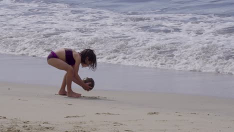 a girl plays and enjoys a sunny day at a mexican beach