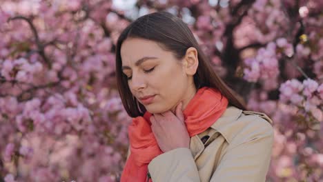 woman with sore throat in springtime